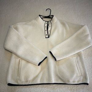 White Sherpa jacket with black detailing, nice and warm and fuzzy on the inside.